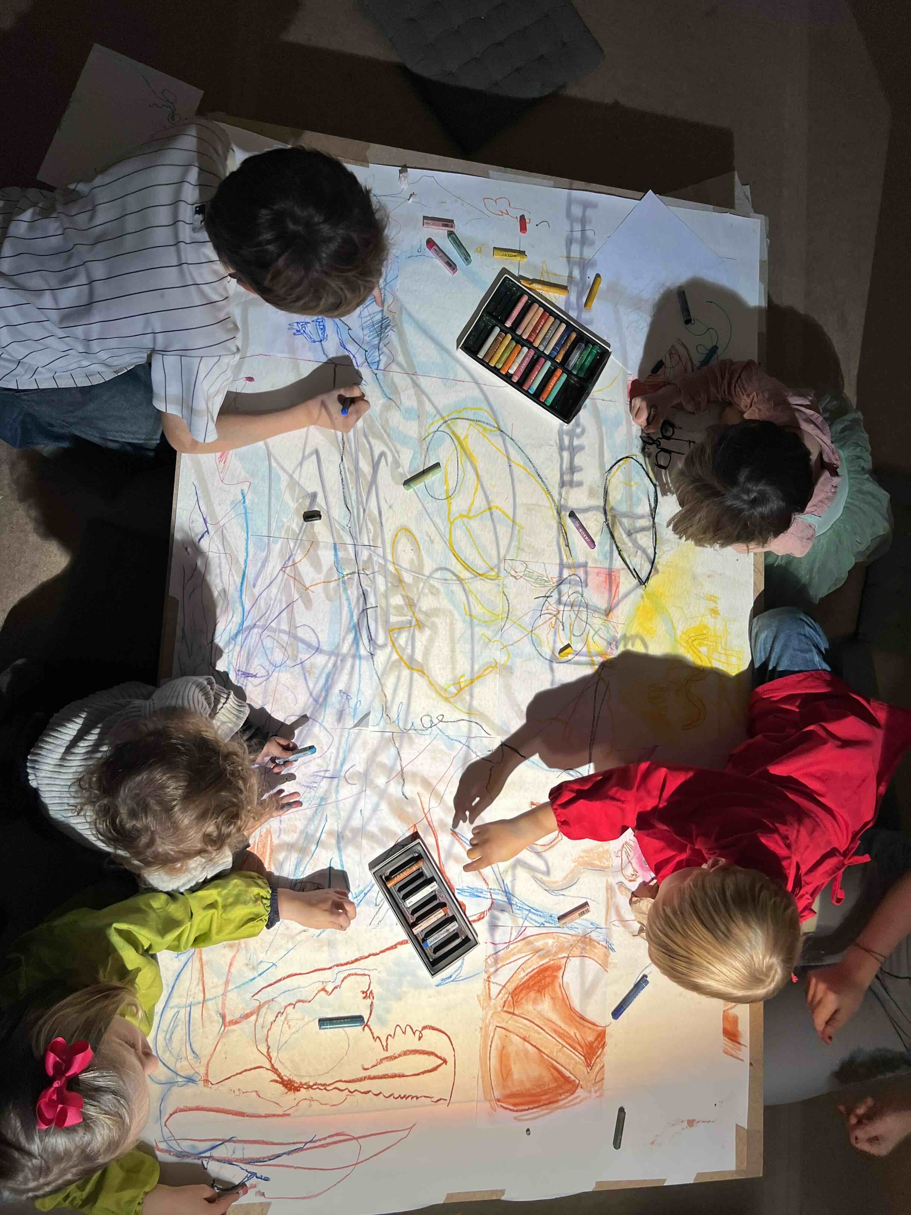 Children drawing together at workshop